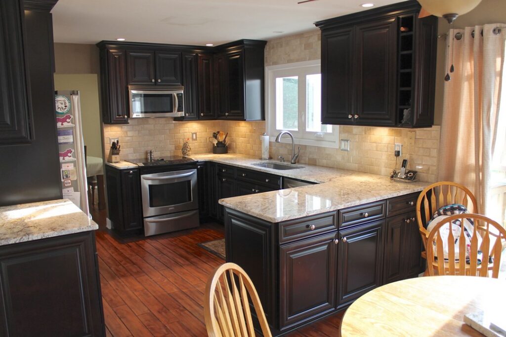 Kitchen remodeling in Warrenton VA with dark wood cabinetry, granite countertops, and tile backsplash