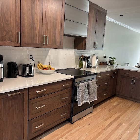 Kitchen design project in Alexandria VA with dark cabinetry, light countertops, and full-height backsplash