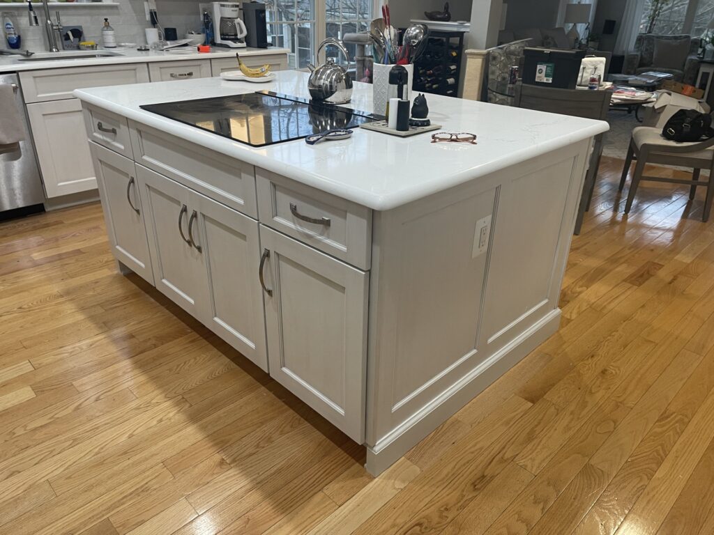 Kitchen remodel in Gainesville VA with white cabinetry island and cooktop