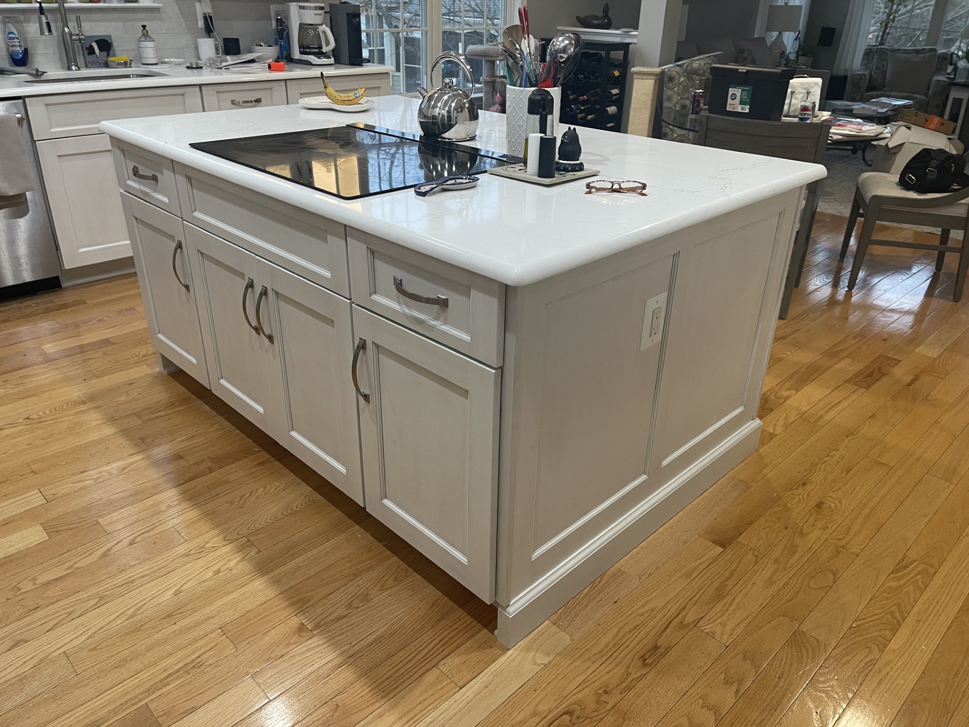 Kitchen remodel in Gainesville VA with white cabinetry island and cooktop