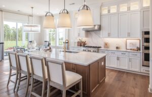 Vienna VA kitchen remodel with white cabinets, large wood island, marble-look backsplash, pendant lighting, and hardwood floors