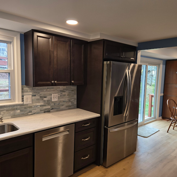 Woodbridge VA kitchen remodel with dark cabinetry, stainless refrigerator, and updated backsplash