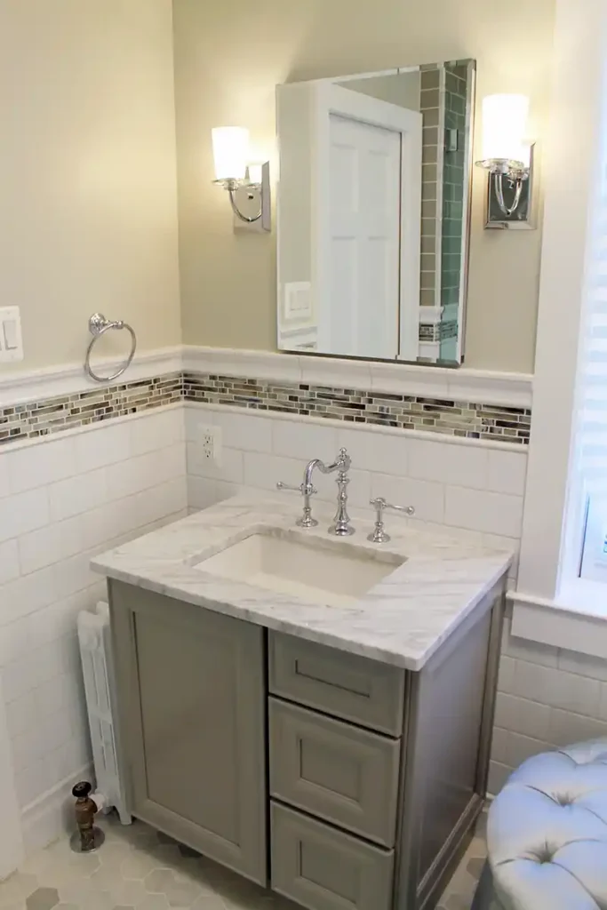 1930s Manassas VA bathroom remodel with gray vanity, marble-look countertop, white subway tile, mosaic accent tile, and chrome fixtures
