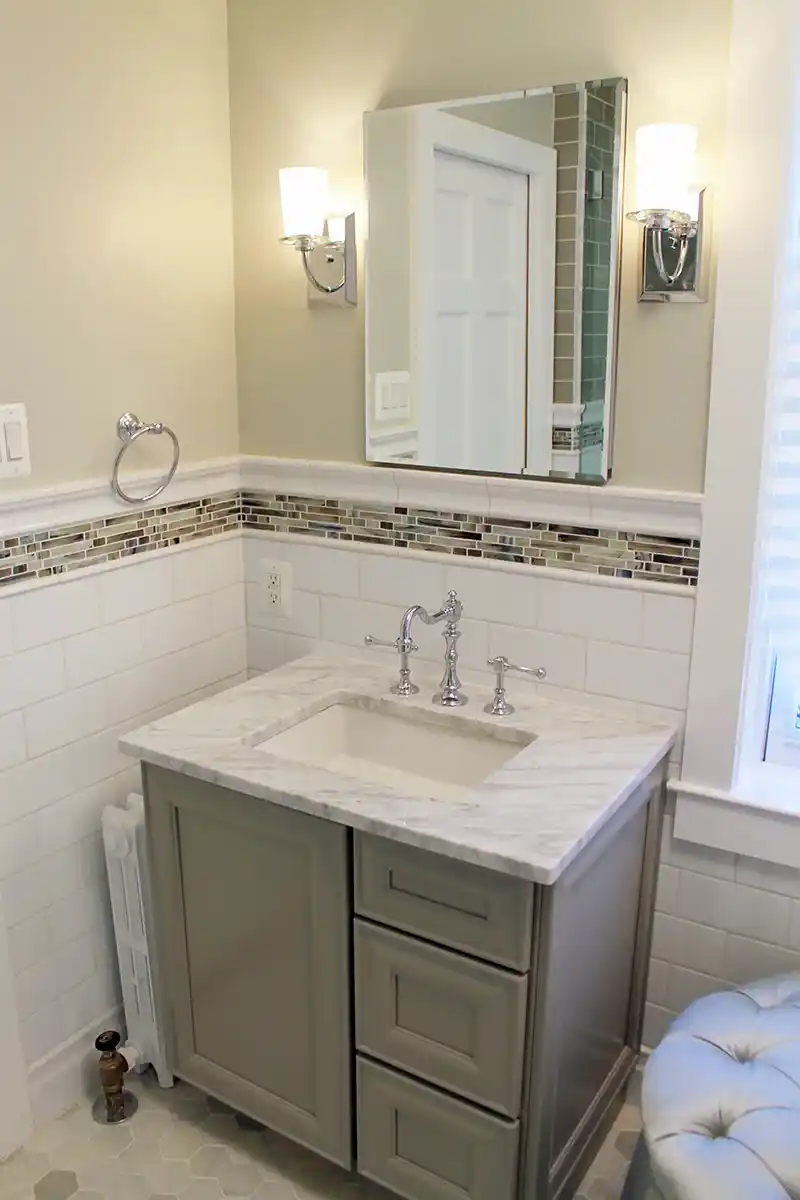 1930s Manassas VA bathroom remodel with gray vanity, marble-look countertop, white subway tile, mosaic accent tile, and chrome fixtures