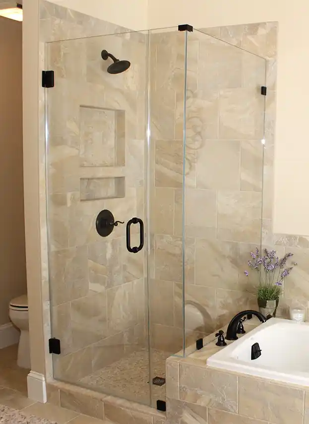 Gainesville VA primary bathroom remodel with glass-enclosed tile shower, clawfoot tub, plantation shutters, and dark bronze fixtures
