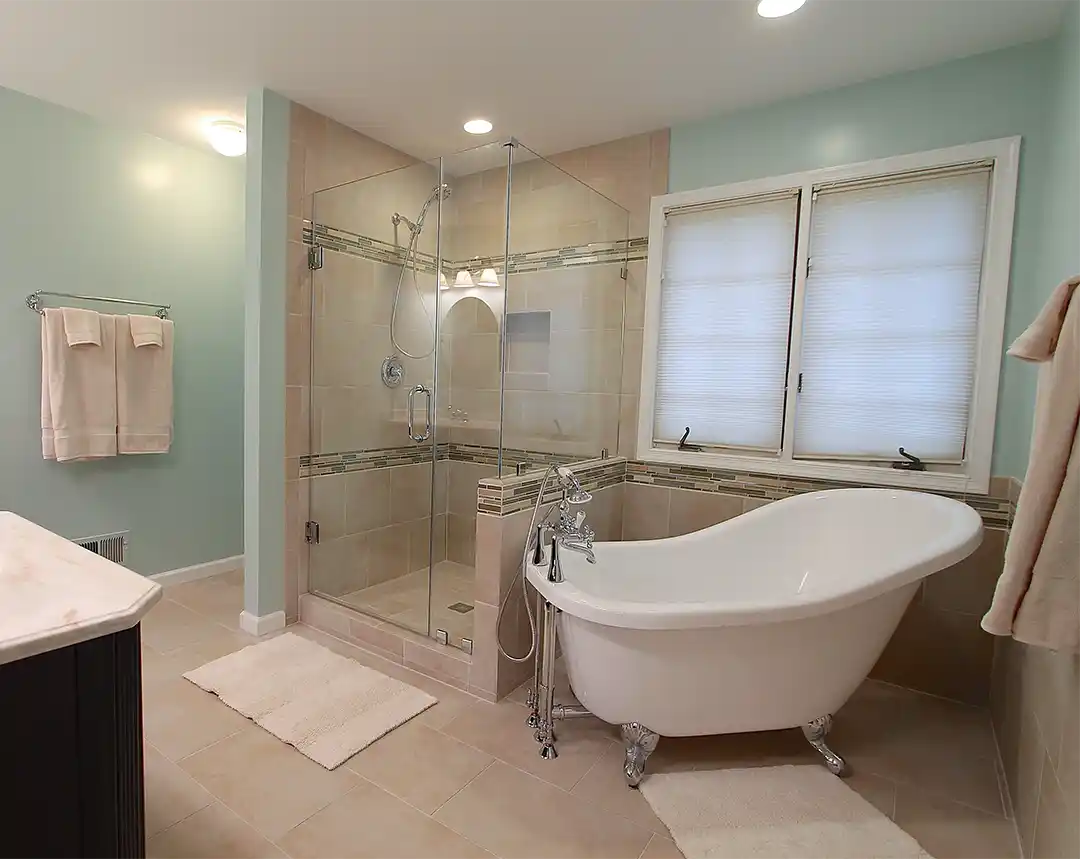 Bristow VA primary bathroom remodel with clawfoot tub, glass-enclosed tile shower, mosaic accent tile, and chrome fixtures