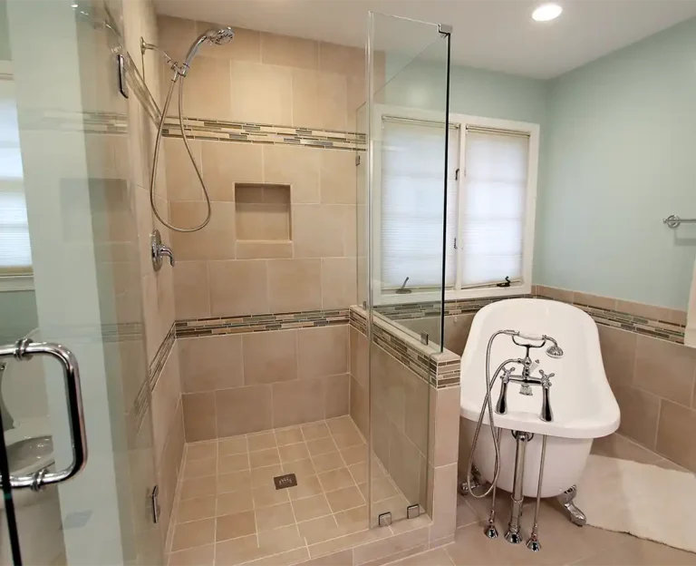 Bristow VA primary bathroom remodel with tile shower, recessed niche, mosaic accent band, clawfoot tub, and chrome fixtures