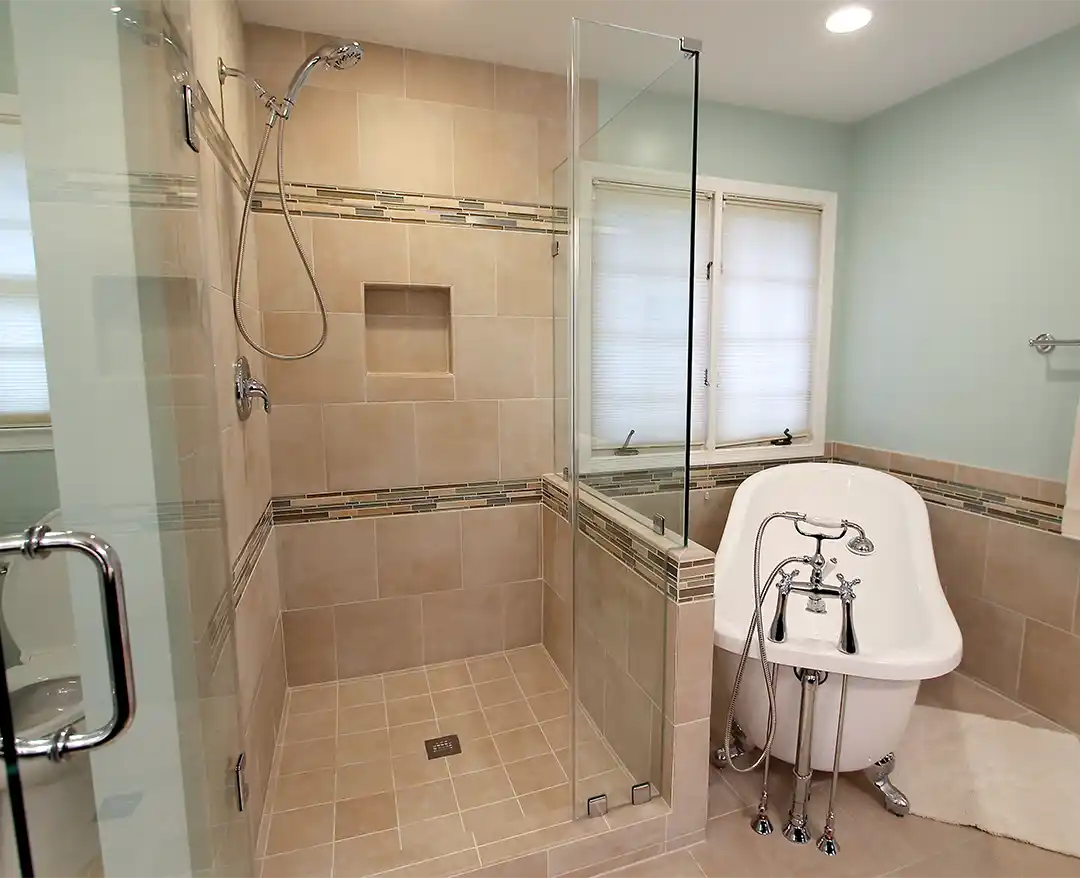 Bristow VA primary bathroom remodel with tile shower, recessed niche, mosaic accent band, clawfoot tub, and chrome fixtures