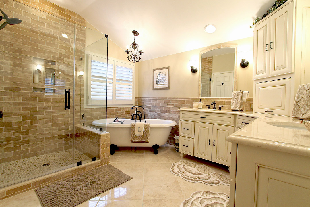 Gainesville VA primary bathroom remodel with tile shower, freestanding tub, double vanity, and custom cabinetry