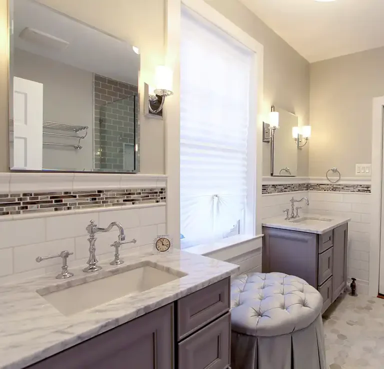 Manassas VA primary bathroom remodel with separate vanities, marble-look countertops, mosaic accent tile, and chrome fixtures