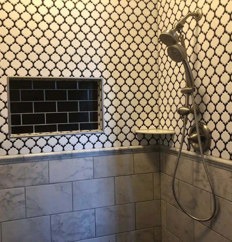 Manassas VA primary bathroom remodel with patterned tile shower, black subway tile niche, marble-look lower wall tile, and brushed metal shower fixtures