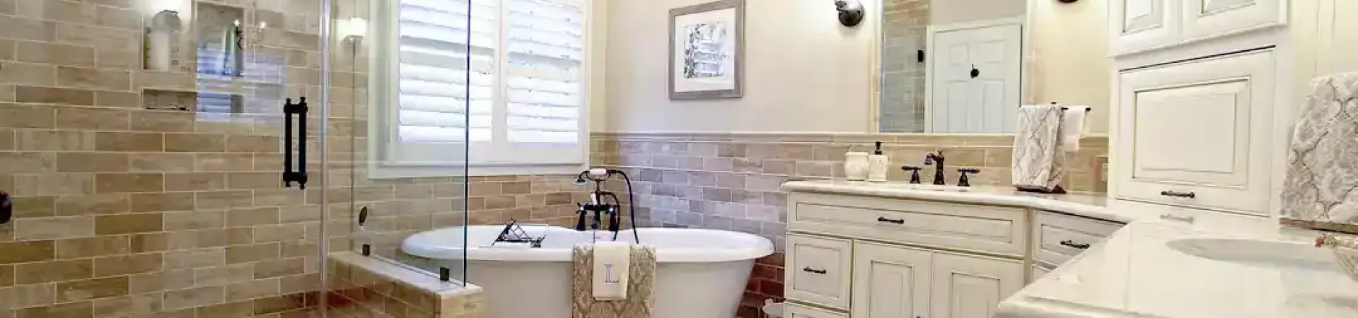 Gainesville VA primary bathroom remodel with tile shower, freestanding tub, double vanity, and custom cabinetry